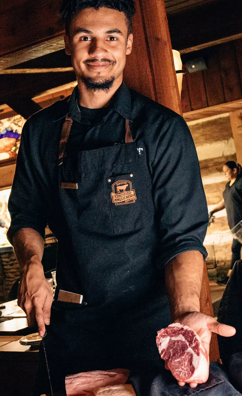 steak peddler holding freshly cut steak