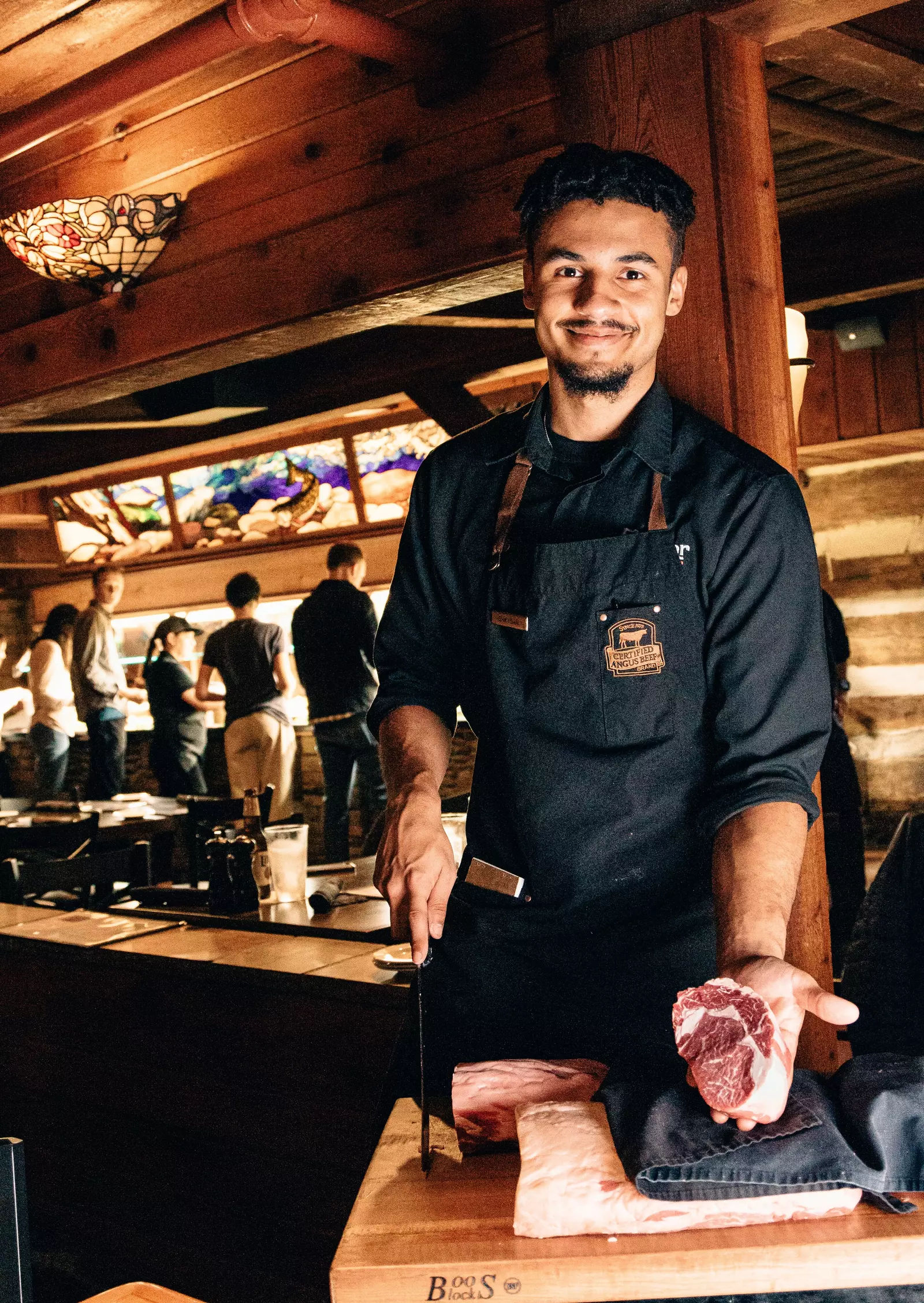 steak peddler holding freshly cut steak