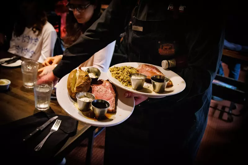 waiter carrying plates of food