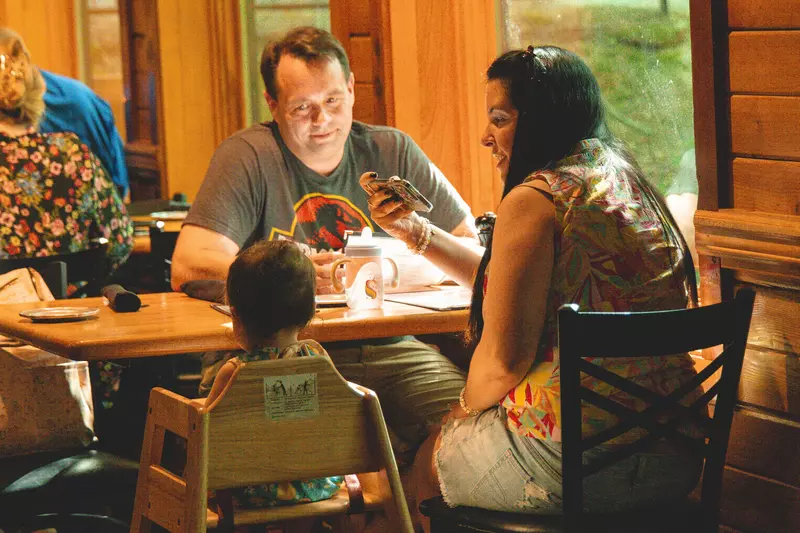 family sitting at table in dining room